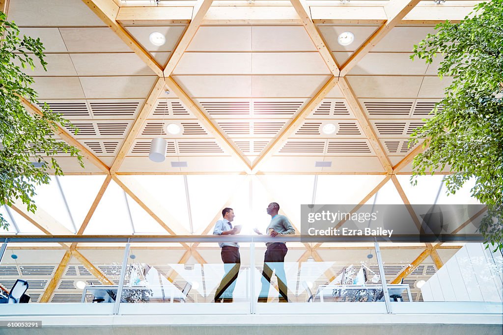 Work colleagues having a catch up in modern office