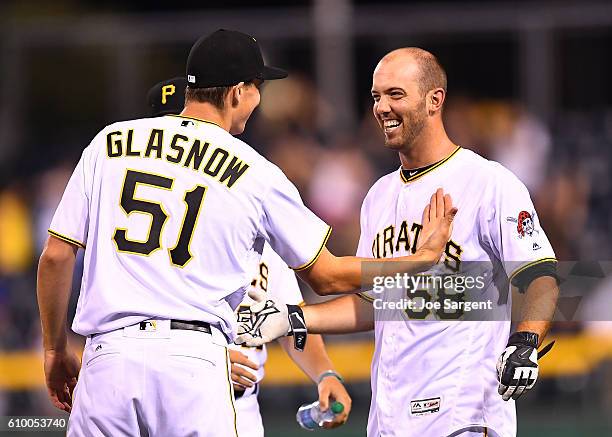 Jacob Stallings of the Pittsburgh Pirates celebrates his game winning RBI single with Tyler Glasnow during the eleventh inning against the Washington...