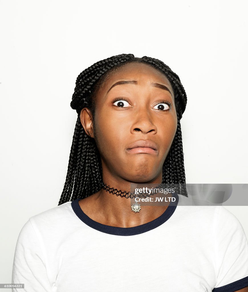Young women pulling faces in photo booth