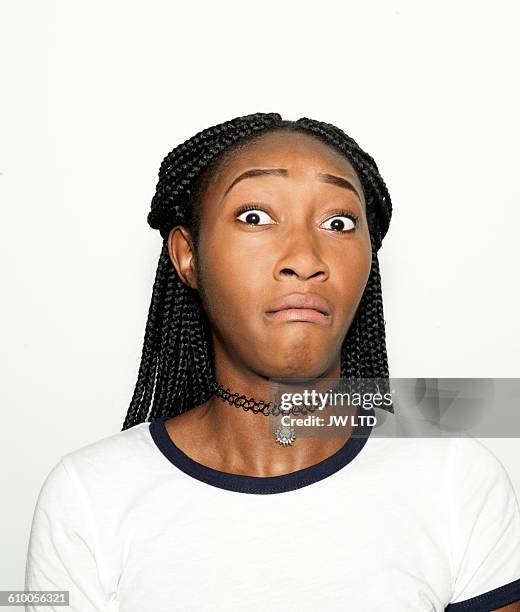 young women pulling faces in photo booth - scared portrait stockfoto's en -beelden