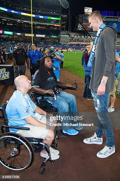Mike Luciano, Eric LeGrand and New York Knicks player Kristaps Porzingis attend the Chicago Fire vs New York City FC match at Yankee Stadium on...