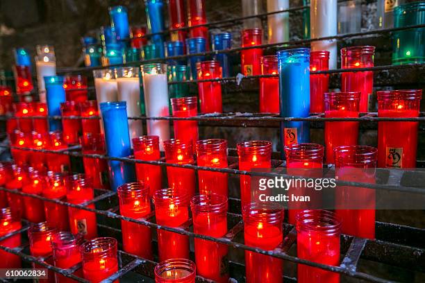 votive candles burning in front of out of focus lights - hatboro stock pictures, royalty-free photos & images