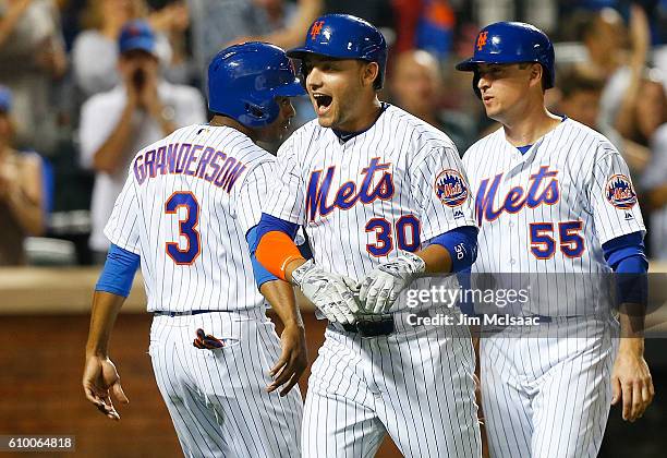 Michael Conforto of the New York Mets celebrates his fifth inning three run home run against the Philadelphia Phillies with teammates Curtis...