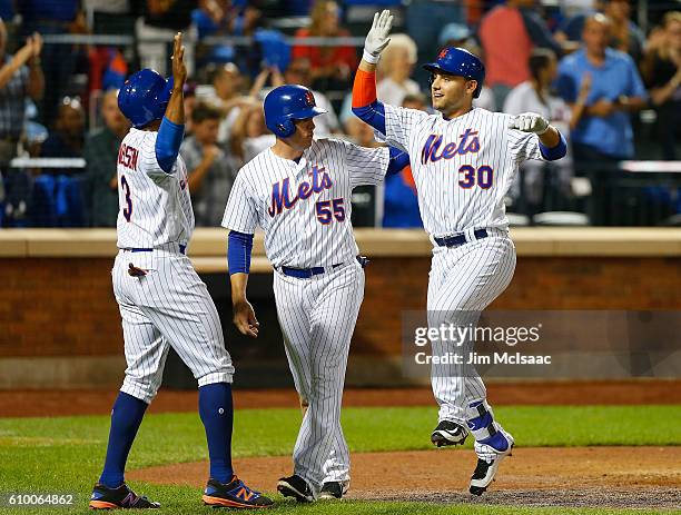 Michael Conforto of the New York Mets celebrates his fifth inning three run home run against the Philadelphia Phillies with teammates Curtis...