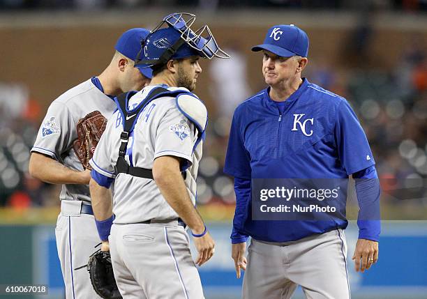 Kansas City Royals pitching coach Dave Eiland talks to catcher Drew Butera and starting pitcher Danny Duffy during the first inning of a baseball...