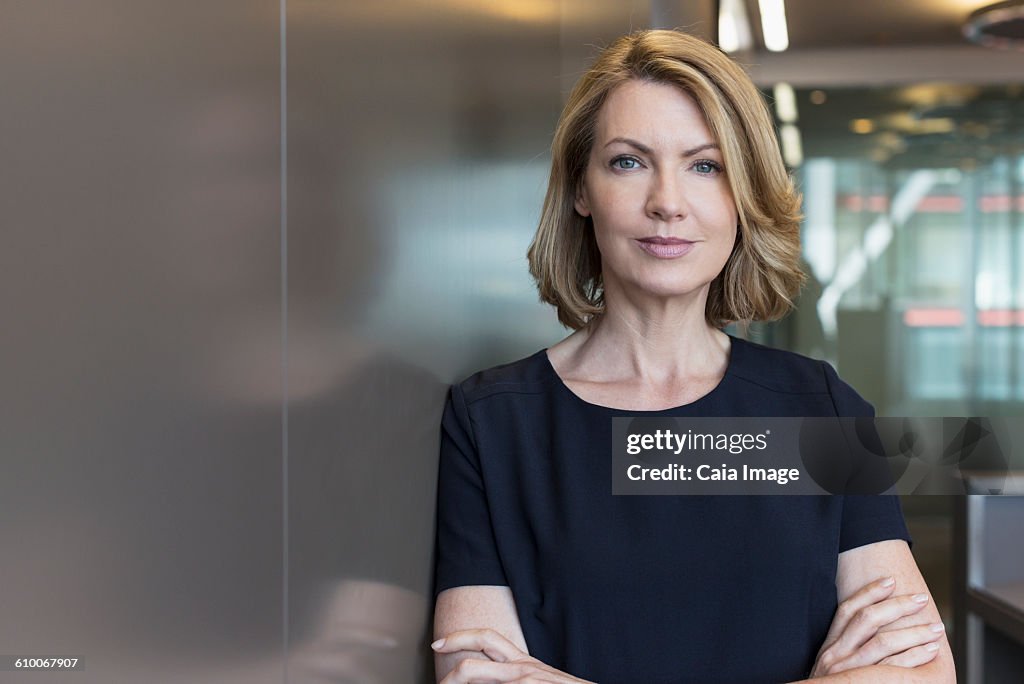 Portrait senior businesswoman with arms crossed
