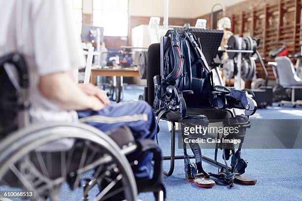 Man in wheelchair near physical therapy equipment