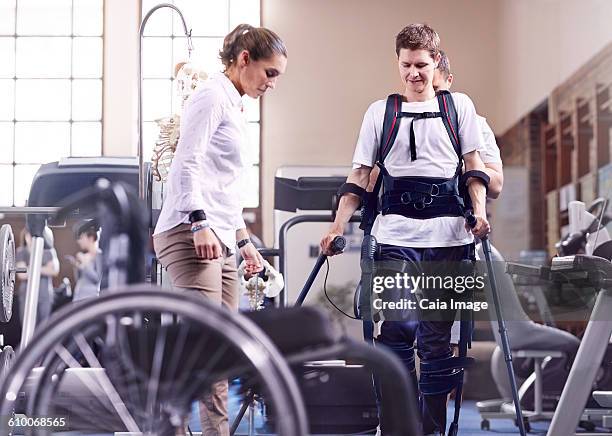 Man with forearm crutches receiving physical therapy