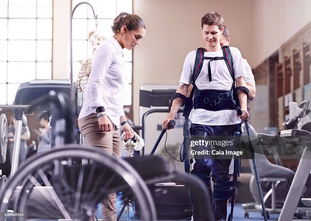 Man with forearm crutches receiving physical therapy