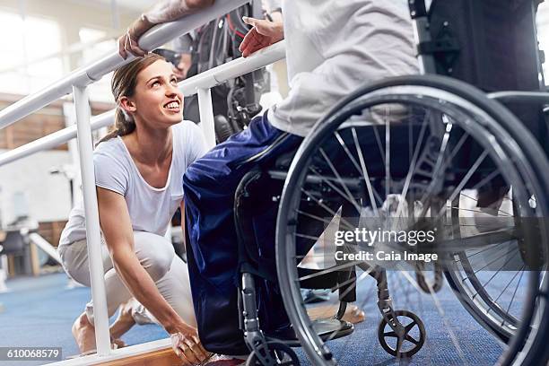 physical therapist preparing man in wheelchair - encouragement stock pictures, royalty-free photos & images