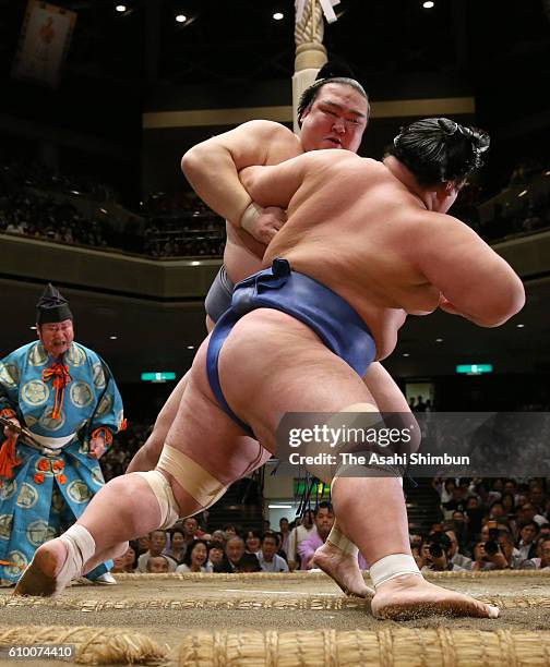 Ozeki Kisenosato throws ozeki Kotoshogiku to win during day ten of the Grand Sumo Autumn Tournament at Ryogoku Kokugikan on September 20, 2016 in...