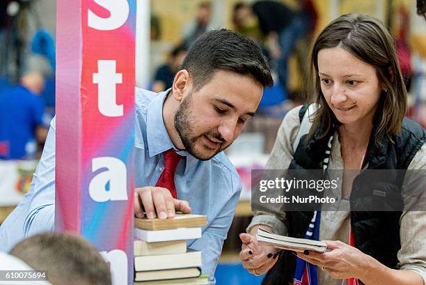 Ionut Georgescu the general manager of Steaua CSM EximBank Bucharest and Ana Maria Popescu , placing a book in the campaign &quot;stands tall...