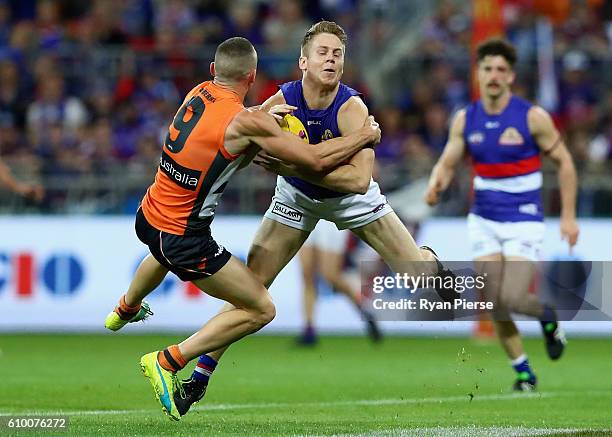 Lachie Hunter of the Bulldogs is tackled by Tom Scully of the Giants during the AFL First Preliminary Final match between the Greater Western Sydney...