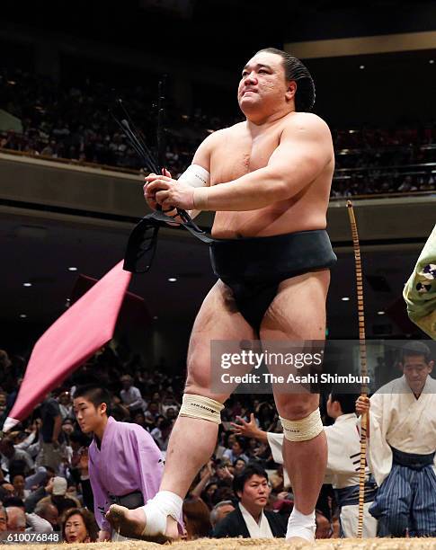 Mongolian yokozuna Harumafuji reacts after his defeat by sekiwake Takayasu during day eleven of the Grand Sumo Autumn Tournament at Ryogoku Kokugikan...