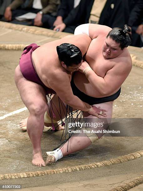 Mitakeumi throws Mongolian ozeki Terunofuji to win during day eleven of the Grand Sumo Autumn Tournament at Ryogoku Kokugikan on September 21, 2016...