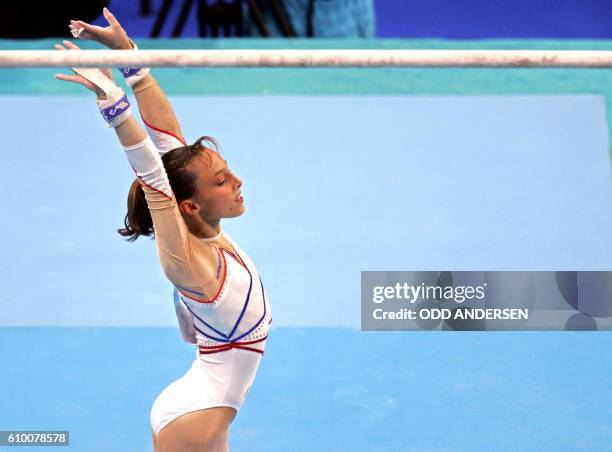 French Emilie Le Pennec celebrates after winning the gold medal in the women's uneven bars final on August 22, 2004 at the Olympic Indoor Hall in...