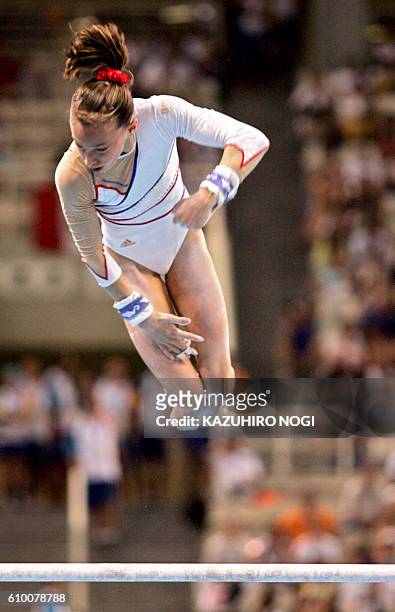 French Emilie Le Pennec performs to win the gold medal in the women's uneven bars final on August 22, 2004 at the Olympic Indoor Hall in Athens...
