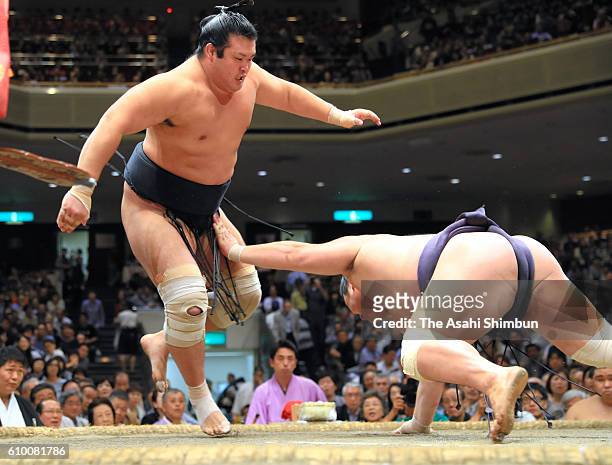 Chiyonokuni pulls down Myogiryu to win during day twelve of the Grand Sumo Autumn Tournament at Ryogoku Kokugikan on September 22, 2016 in Tokyo,...