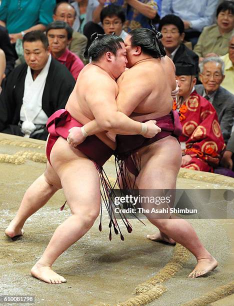 Endo pushes Mitakeumi out of the ring to win during day twelve of the Grand Sumo Autumn Tournament at Ryogoku Kokugikan on September 22, 2016 in...