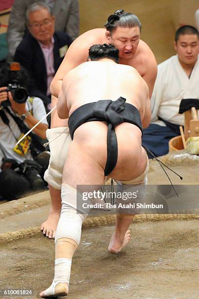 Aminishiki pushes Mongolian wrestler Higashiryu to win in the Juryo rank during day twelve of the Grand Sumo Autumn Tournament at Ryogoku Kokugikan...