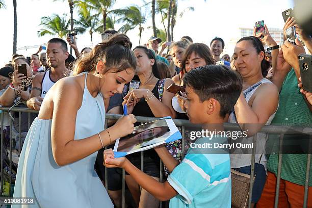 Actor Teilor Grubbs signs an autograph for a fan as she arrives at the CBS 'Hawaii Five-0' Sunset On The Beach Season 7 Premier Event at Queen's Surf...