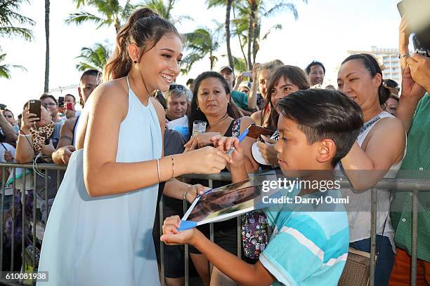 Actor Teilor Grubbs signs an autograph for a fan as she arrives at the CBS 'Hawaii Five-0' Sunset On The Beach Season 7 Premier Event at Queen's Surf...