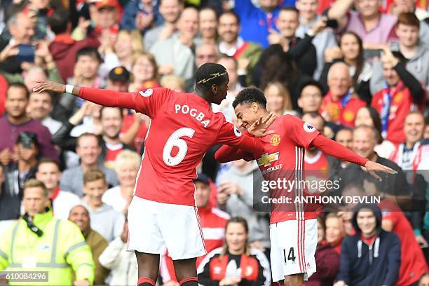 Manchester United's French midfielder Paul Pogba and Manchester United's English midfielder Jesse Lingard celebrate after Pogba scored their fourth...