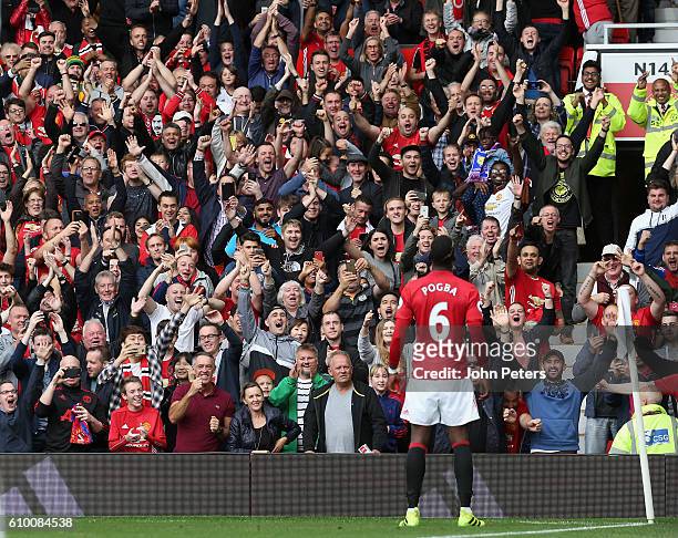 Paul Pogba of Manchester United celebrates scoring their fourth goal in front of the home fans during the Premier League match between Manchester...