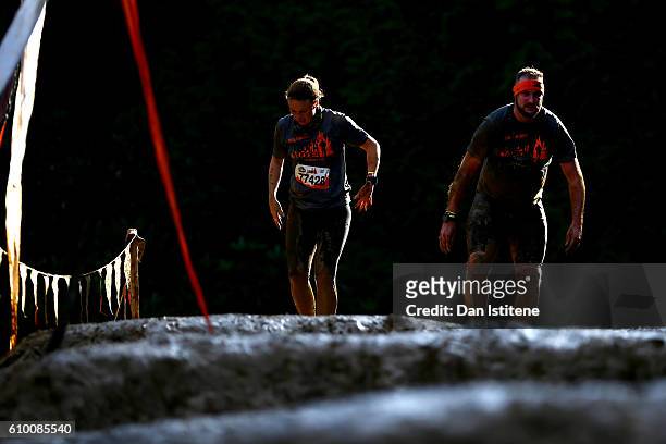 Participants tackle the Mud Mile during the 2016 Tough Mudder - London South at Holmbush Farm on September 24, 2016 in Horsham, England.