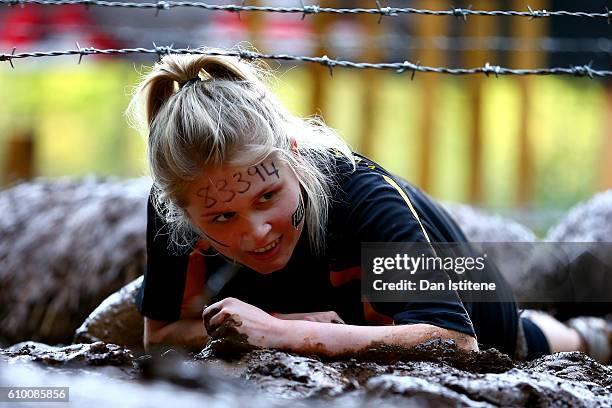 Participant tackles the Kiss of Mud during the 2016 Tough Mudder - London South at Holmbush Farm on September 24, 2016 in Horsham, England.