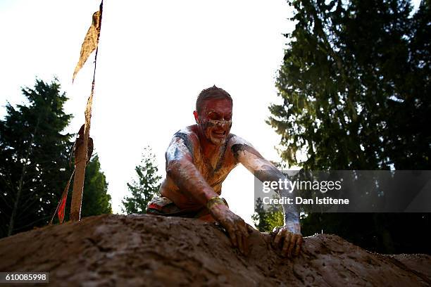 Participant tackles the Mud Mile during the 2016 Tough Mudder - London South at Holmbush Farm on September 24, 2016 in Horsham, England.