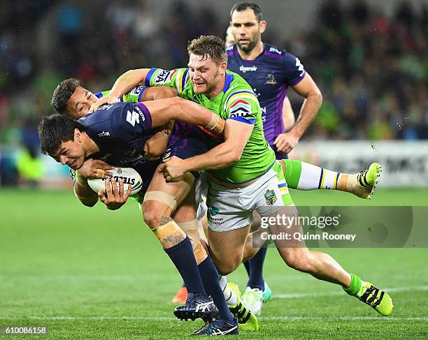 Jordan McLean of the Storm is tackled during the NRL Preliminary Final match between the Melbourne Storm and the Canberra Raiders at AAMI Park on...