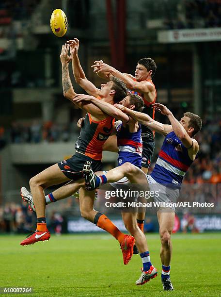 Rory Lobb of the Giants, Fletcher Roberts of the Bulldogs, Jonathon Patton of the Giants and Dale Morris of the Bulldogs compete for the ball during...