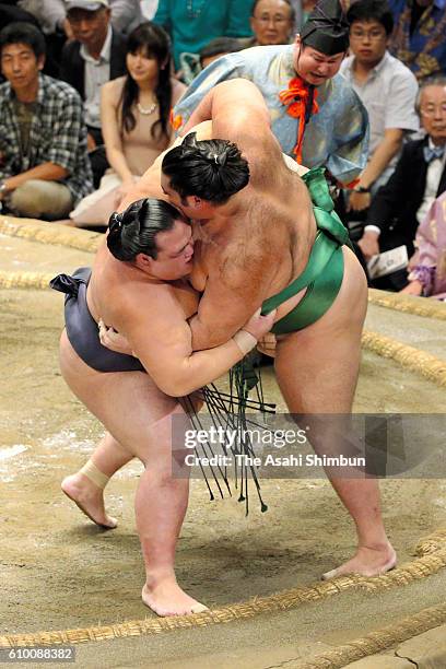 Ozeki Kisenosato throws Brazilian komusubi Kaisei to win during day twelve of the Grand Sumo Autumn Tournament at Ryogoku Kokugikan on September 22,...