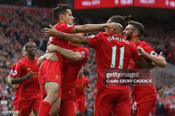 Liverpool's English midfielder Adam Lallana is congratelated by teammates after scoring his team's first goal during the English Premier League...