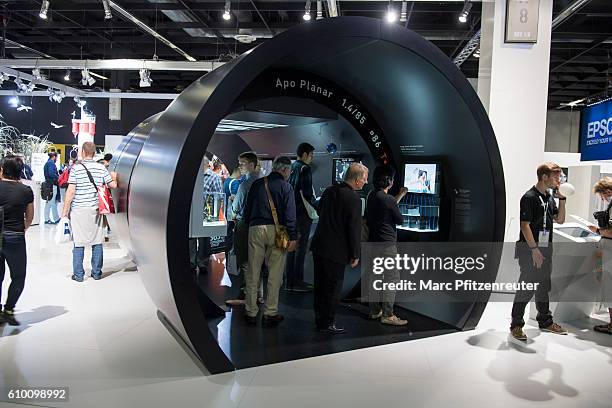 Visitors at the Zeiss booth at the 2016 Photokina trade fair on September 24, 2016 in Cologne, Germany. Photokina is the world's largest trade fair...