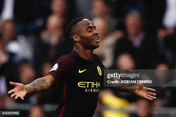 Manchester City's English midfielder Raheem Sterling celebrates scoring their third goal during the English Premier League football match between...