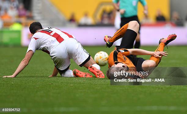 Jon Dadi Bodvarsson of Wolverhampton Wanderers rolls over in pain after a tackle by John Egan of Brentford during the Sky Bet Championship match...