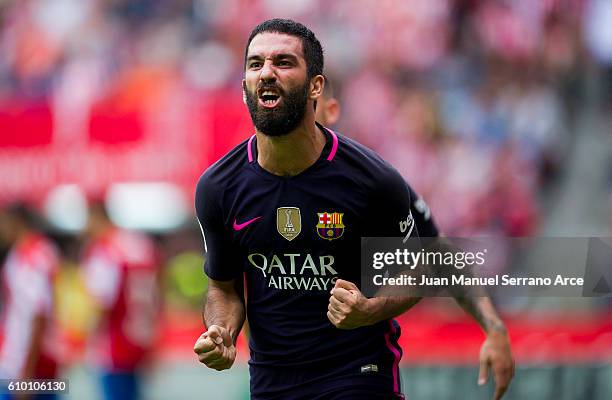 Arda Turan of FC Barcelona celebrates after scoring his team's fourth goal during the La Liga match between Real Sporting de Gijon and FC Barcelona...