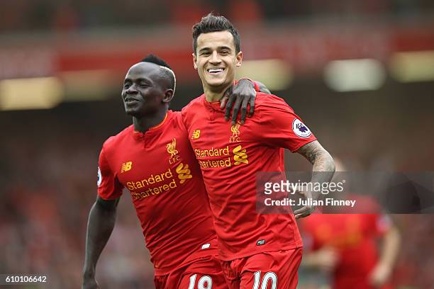Philippe Coutinho of Liverpool celebrates with Sadio Mane as he scores their fourth goal during the Premier League match between Liverpool and Hull...