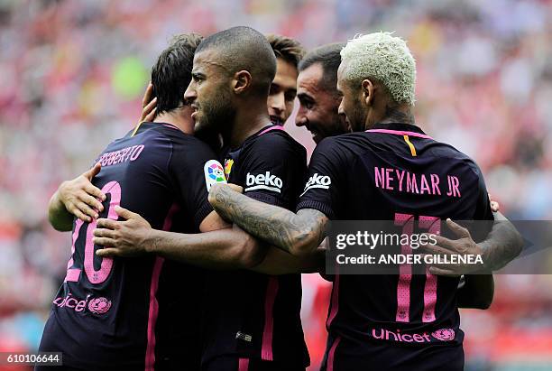 Barcelona's Brazilian forward Neymar da Silva Santos Junior celebrates with teammates after scoring his team's third goal during the Spanish league...