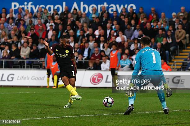 Manchester City's English midfielder Raheem Sterling slots the ball past Swansea City's Polish goalkeeper Lukasz Fabianski to score their third goal...
