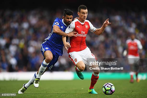 Diego Costa of Chelsea and Laurent Koscielny of Arsenal battle for possession during the Premier League match between Arsenal and Chelsea at the...