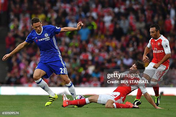 Arsenal's Spanish defender Hector Bellerin stretches to tackle Chelsea's Serbian midfielder Nemanja Matic during the English Premier League football...