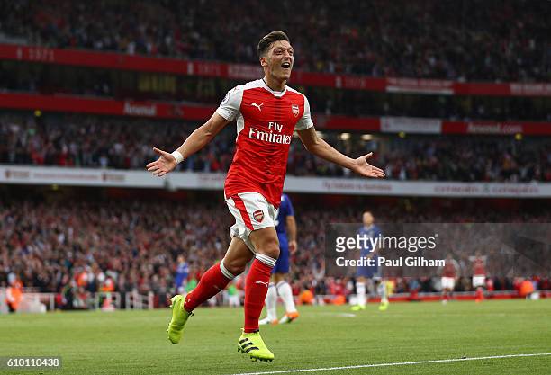 Mesut Ozil of Arsenal celebrates scoring his sides third goal during the Premier League match between Arsenal and Chelsea at the Emirates Stadium on...