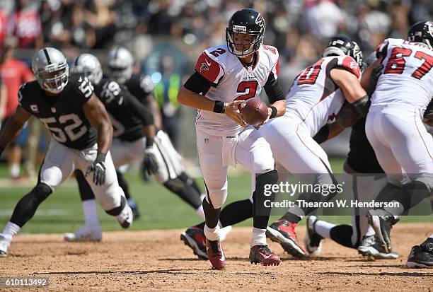 Matt Ryan of the Atlanta Falcons turns to hand the ball off to a running back against the Oakland Raiders in the first haft of their NFL game at...