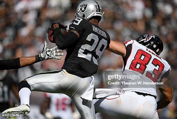 David Amerson of the Oakland Raiders intercepts a pass intended for Jacob Tamme of the Atlanta Falcons in the second half during their NFL game at...