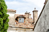 Old roof with clay roofing and chimneys in Trebinje.