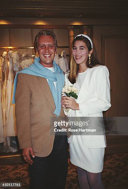 American fashion designer Michael Kors with a model in bridalwear, USA, 1991.