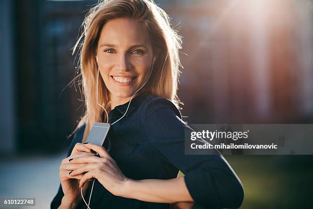 happy young woman with headphones enjoying the day - lady relaxing in sun radio stock pictures, royalty-free photos & images